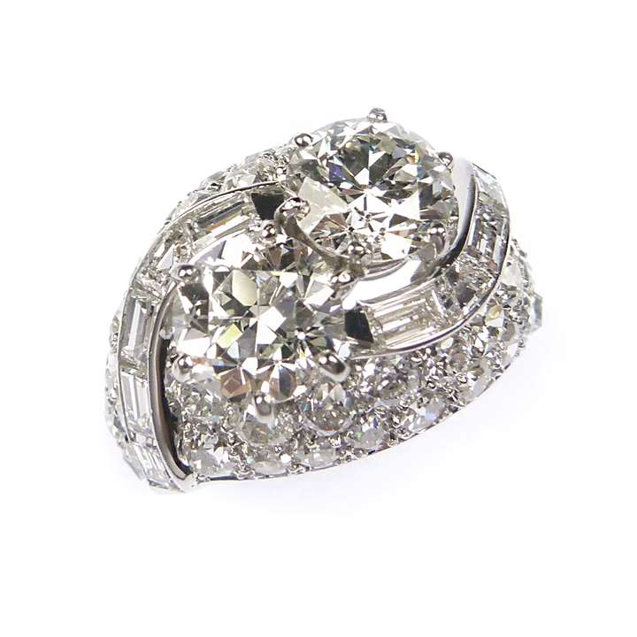 Two stone diamond bombe cluster ring  topped by principal round brilliant cut stones